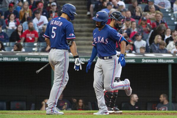 Texas Rangers' Corey Seager, left, greets Marcus Semien after his solo home run off Cleveland Guardians starting pitcher Kirk McCarty during the third inning of the second game of a baseball doubleheader in Cleveland, Tuesday, June 7, 2022. (AP Photo/Phil Long)