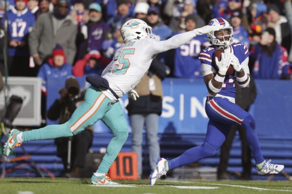 FILE - Buffalo Bills wide receiver Stefon Diggs, right, grabs a pass in front of Miami Dolphins cornerback Xavien Howard (25) during the first half of an NFL wild-card playoff football game Jan. 15, 2023, in Orchard Park, N.Y. Though Bills quarterback Josh Allen blames the media for making too much of Diggs' absence for the start of the Bills mandatory minicamp, the team's premier receiver has yet to publicly address what happened, and address the lingering issues he had carrying over from last season. (AP Photo/Joshua Bessex, File)