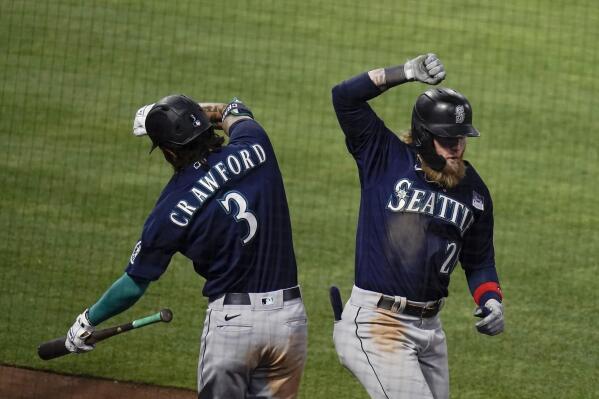 Seattle Mariners' Jake Fraley, right, celebrates his three-run home run with J.P. Crawford during the fourth inning of the team's baseball game against the Los Angeles Angels in Anaheim, Calif., Thursday, June 3, 2021. (AP Photo/Jae C. Hong)