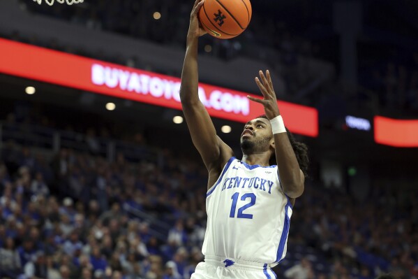 Kentucky's Antonio Reeves (12) takes an uncontested shot during the first half of an NCAA college basketball game against Marshall in Lexington, Ky., Friday, Nov. 24, 2023. (AP Photo/James Crisp)