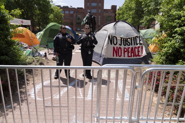 George Washington University police close the student encampment as students protest on the street during a pro-Palestinian protest over the Israel-Hamas war on Friday, April 26, 2024, in Washington. (AP Photo/Jose Luis Magana)
