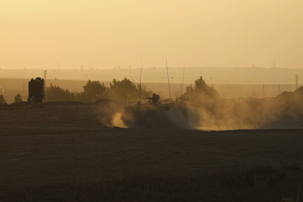 An Israeli armoured personnel carrier (APC) moves near the Gaza Strip border in southern Israel, Wednesday, Oct. 25, 2023. (AP Photo/Tsafrir Abayov)