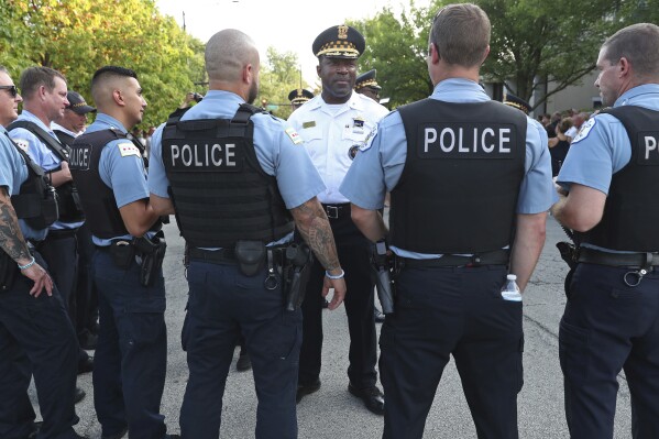 Deputy Chief Larry Snelling, center, talks with officers before a prayer service in memory of Officer Ella French outside the 22nd District, 1900 W. Monterey Ave., on Aug. 11, 2021, in Chicago. Chicago Mayor Brandon Johnson on Sunday, Aug. 13, 2023, named Snelling, the police department's counterterrorism head, as his choice for police superintendent of the nation's third-largest city. (John J. Kim/Chicago Sun-Times via AP)