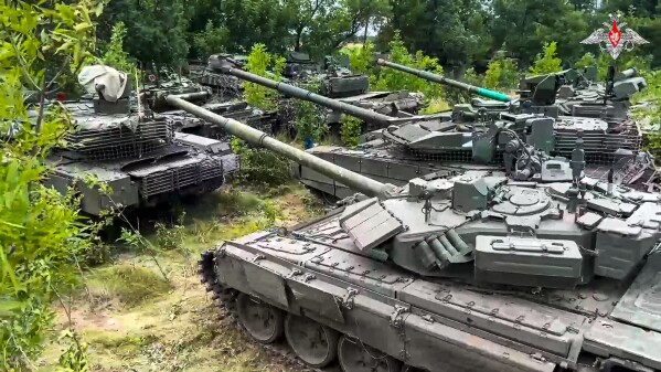 In this photo released by Russian Defense Ministry Press Service on Wednesday, July 12, 2023, Tanks belonging to Russia's Wagner military contractor are parked ahead of their handover to the Russian military at an undisclosed location. The Russian Defense Ministry said that Wagner Group is completing the handover of its weapons to the Russian military. The move follows Wagner's short-lived mutiny last month that challenged the Kremlin. (Russian Defense Ministry Press Service via AP)