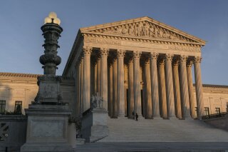 FILE - In this Nov. 6, 2020, file photo, the Supreme Court is seen at sundown in Washington. The Supreme Court appears ready to side with two California agriculture businesses that want to bar labor organizers from their property. (AP Photo/J. Scott Applewhite, File)