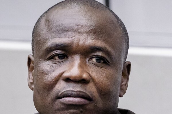 FILE - Dominic Ongwen sits in the court room to listen to the Appeals Chamber of the International Criminal Court's judgment on the Defence's appeals against his conviction and sentence in The Hague, Netherlands, Dec. 15, 2022. Judges at the International Criminal Court on Wednesday, Feb. 28, 2024, granted reparations of more than 52 million euros ($56 million) to tens of thousands of victims of the convicted commander in the the shadowy Ugandan rebel group the Lord's Resistance Army, including former child soldiers and children born as a result of rapes and forced pregnancies. (Sem van der Wal/Pool Photo via AP)