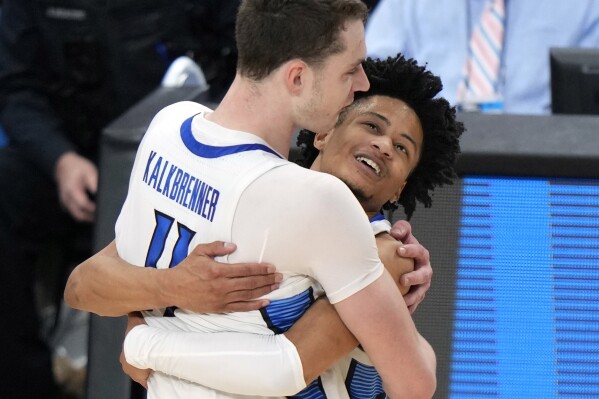 Creighton's Ryan Kalkbrenner (11) celebrates with Trey Alexander after a double overtime win in a second-round college basketball game in the NCAA Tournament against Oregon in Pittsburgh, Sunday, March 24, 2024. (AP Photo/Gene J. Puskar)