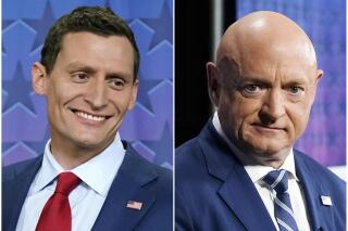 This combination of photos shows Arizona Republican Senate candidate Blake Masters, left, and Sen. Mark Kelly, D-Ariz., before a televised debate in Phoenix, Oct. 6, 2022. (AP Photo/Ross D. Franklin)