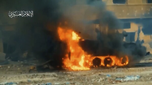 In this image from video released by Hamas on Dec. 6, 2023, an Israeli armored vehicle burns following an attack by militants in Gaza City. In the two months since Israel invaded Gaza, Hamas has posted multiple videos of its fighters attacking Israeli tanks and armored personal carriers with Al-Yasin 105 shoulder-fired rockets. Cobbled together by militants in Gaza, the rockets are a copy of the Russian-made PG-7VR, which features a tandem warhead specifically designed to defeat reactive-armor systems like that used on Israeli tanks. Watermark at upper left reads “military media.” (Hamas via AP)