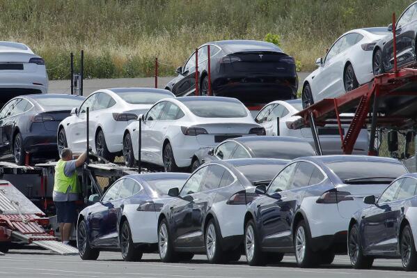 FILE - In this May 13, 2020, file photo, Tesla cars are loaded onto carriers at the Tesla electric car plant in Fremont, Calif. California wants electric vehicle sales to triple in the next four years to 35% of all new car purchases. Regulations passed Tuesday, April 12, 2022 by the California Air Resources Board set a roadmap for the state to achieve California Gov. Gavin Newsom's ambitious goal of phasing out the sale of new gas powered cars. The draft must go through a months-long state regulatory process and get approval from the U.S. EPA. (AP Photo/Ben Margot, File)