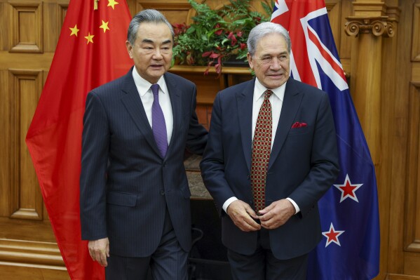 China's Minister of Foreign Affairs Wang Yi, left, meets his New Zealand counterpart Winston Peters, in Wellington, New Zealand, Monday, March 18, 2024. (Hagen Hopkins/Pool Photo via AP)