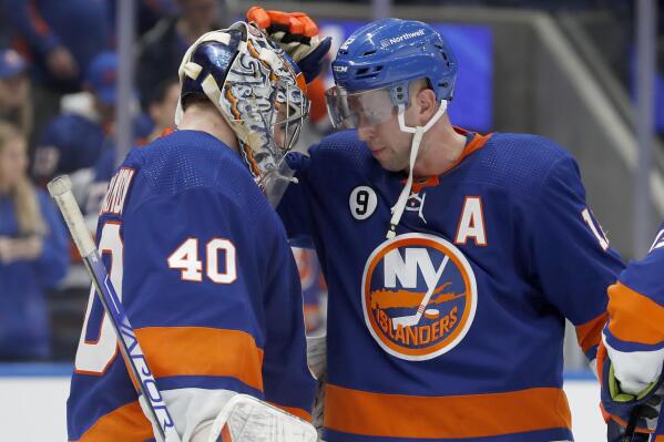 New York Islanders right wing Josh Bailey, right, and goaltender Semyon Varlamov (40) celebrate after the Islanders defeated the Winnipeg Jets in an NHL hockey game Friday, March 11, 2022, in Elmont, N.Y. (AP Photo/Jim McIsaac)