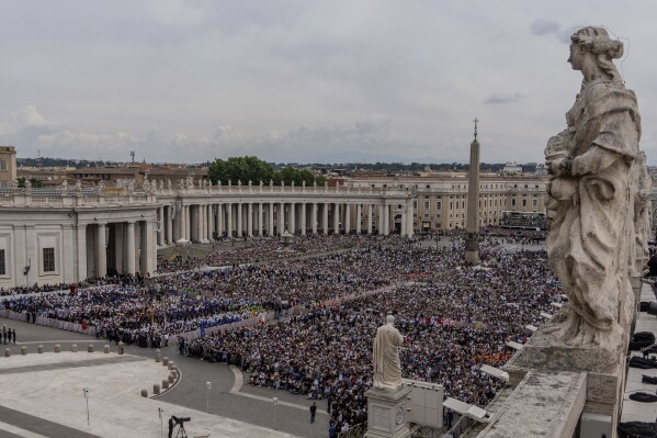 A crowd gathers in St. Peter's Square at the Vatican, where newly elected Pope Leo XIV will deliver a blessing from the central balcony of St. Peter's Basilica on Sunday, May 11, 2025. (AP Photo/Domenico Stinellis, File)