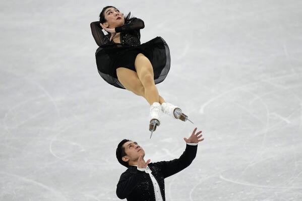 Sui Wenjing and Han Cong, of China, compete in the pairs short program during the figure skating competition at the 2022 Winter Olympics, Friday, Feb. 18, 2022, in Beijing. (AP Photo/David J. Phillip)