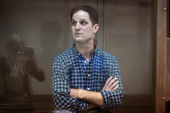 FILE - Wall Street Journal reporter Evan Gershkovich stands in a glass cage in a courtroom at the Moscow City Court, in Moscow, Russia, April 18, 2023. On Monday, Aug. 14, 2023, U.S. Ambassador to Russia Lynne Tracy made her third visit to Gershkovich, who has been behind bars in Russia since March on charges of espionage. (AP Photo/Alexander Zemlianichenko, File)