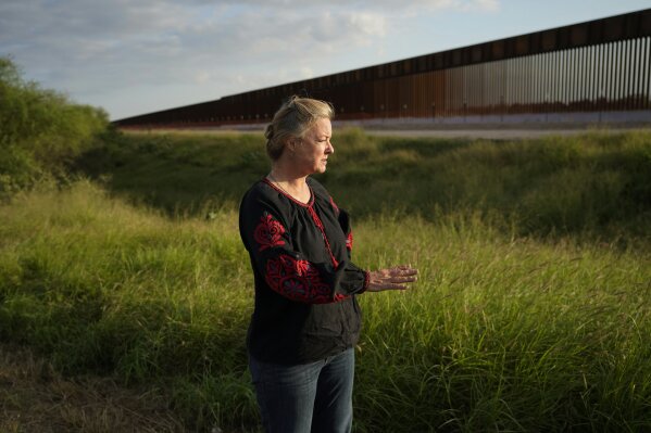 In this Monday, Nov. 16, 2020, photo, Marianna Trevino Wright, executive director of the National Butterfly Center, talks about the issues and challenges that will be caused to wildlife by new border wall being built in Mission, Texas. (AP Photo/Eric Gay)