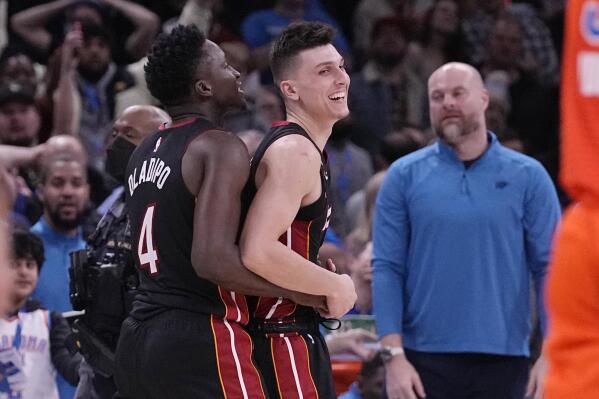 Miami Heat guard Tyler Herro, right, celebrates with teammate, Victor Oladipo, left, after the Miami Heat defeated the Oklahoma City Thunder in an NBA basketball game Wednesday, Dec. 14, 2022, in Oklahoma City. (AP Photo/Sue Ogrocki)