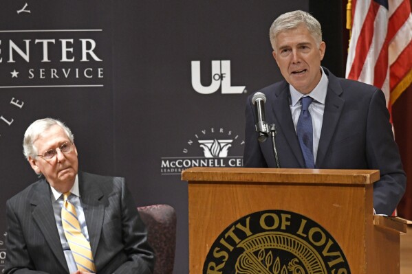 FILE - As Sen. Mitch McConnell, R-Ky., left, listens, Supreme Court Justice Neil Gorsuch speaks to an audience at the University of Louisville, Sept. 21, 2017, in Louisville, Ky. (AP Photo/Timothy D. Easley, File)