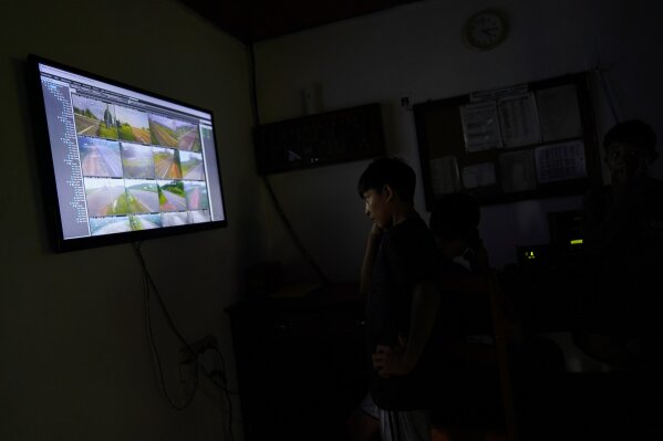
              A Waimiri-Atroari youth looks at a screen showing varopis cameras placed on the vast Waimiri-Atroari reserve in Brazil's Amazon state, Wednesday, Feb. 27, 2019. Non-tribal members in general are usually forbidden to enter the sprawling reserve that is the size of Israel and straddles the states of Amazonas and Roraima. (AP Photo/Victor R. Caivano)
            