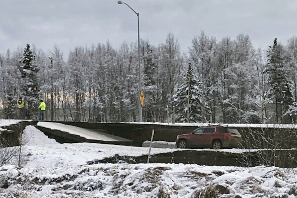 
              A car is trapped on a collapsed section of the offramp off of Minnesota Drive in Anchorage, Friday, Nov. 30, 2018. Back-to-back earthquakes measuring 7.0 and 5.8 rocked buildings and buckled roads Friday morning in Anchorage, prompting people to run from their offices or seek shelter under office desks, while a tsunami warning had some seeking higher ground. (AP Photo/Dan Joling)
            