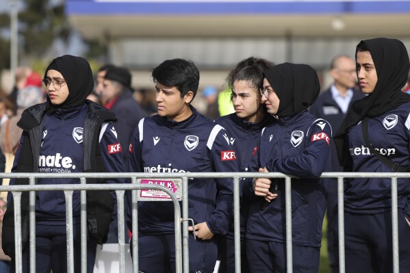 Members of the Afghan women's football team attend Morocco's practice ahead of the Women's World Cup in Melbourne, Australia, Wednesday, July 19, 2023. Some of the team left Afghanistan after the Taliban retook power in 2021 and came out to support the Moroccan women and show that Muslim women belong in sports. (AP Photo/Victoria Adkins)