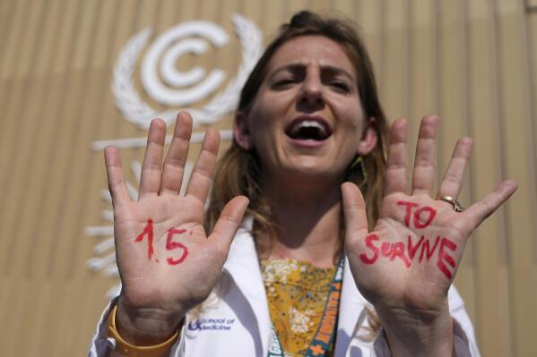 FILE - A demonstrator shows her hands reading "1.5 to survive" at a protest advocating for the warming goal at the COP27 U.N. Climate Summit, Nov. 16, 2022, in Sharm el-Sheikh, Egypt. There’s a two-out-of-three chance within the next five years that the world will temporarily reach the internationally accepted global temperature threshold for limiting the worst effects of climate change, a new World Meteorological Organization report forecasts on Wednesday, May 17, 2023. (AP Photo/Peter Dejong, File)