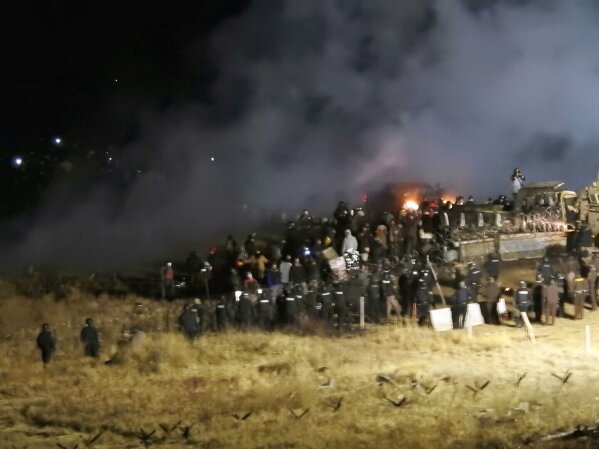 FILE - In this Nov. 20, 2016 file photo, provided by Morton County Sheriff's Department, law enforcement and protesters clash near the site of the Dakota Access pipeline on Sunday, Nov. 20, 2016, in Cannon Ball, N.D. A federal judge on Monday, July 6, 2020 sided with the Standing Rock Sioux Tribe and ordered the Dakota Access pipeline to shut down until more environmental review is done. (Morton County Sheriff's Department via AP, File)