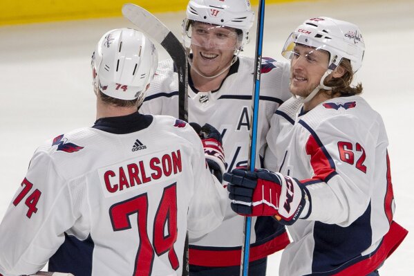 Washington Capitals centre Nicklas Backstrom (19) celebrates with teammates John Carlson (74) and Carl Hagelin (62) after scoring the fourth goal against the Montreal Canadiens during third period NHL hockey action Monday, Jan. 27, 2020 in Montreal. (Ryan Remiorz/The Canadian Press via AP)