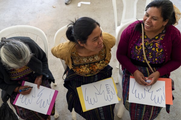 Indigenous women attend a support group during an event organized by the Jesuit Migrant Network that provides support to the relatives of migrants who died trying to reach the U.S. in Comitancillo, Guatemala, Monday, March 18, 2024. Many families credit the Jesuit group for being the only institution that has stayed by their side, regularly traveling to Comitancillo to provide legal updates as well as psychological, humanitarian, and pastoral assistance. (AP Photo/Moises Castillo)