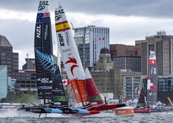 New Zealand SailGP Team helmed by Peter Burling and Spain SailGP Team helmed by Diego Botin battle for position during the second race on the first day of the Canada Sail Grand Prix in Halifax, Nova Scotia, Saturday, June 1, 2024. (Simon Bruty/SailGP via AP)