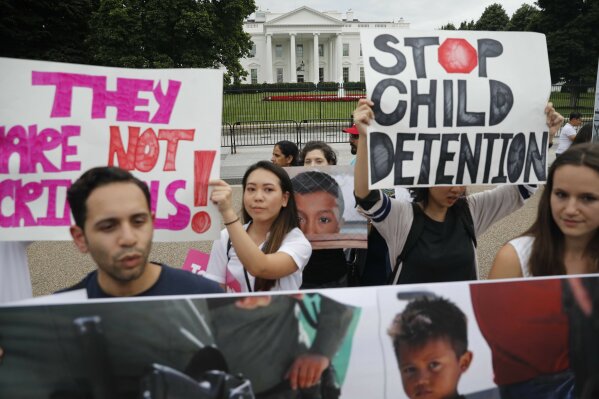 
              People hold up signs and photographs during a  demonstration opposed to the White House policy that separated more than 2,300 children from their parents over the past several weeks in front of the White House in Washington, Thursday, June 21, 2018. (AP Photo/Pablo Martinez Monsivais)
            