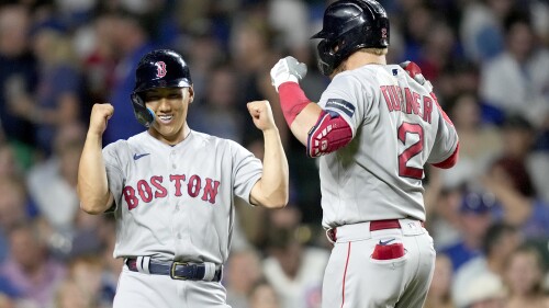 Boston Red Sox's Masataka Yoshida, left, celebrate with Justin Turner after Turner's two-run home run off Chicago Cubs relief pitcher Mark Leiter Jr. during the seventh inning of a baseball game Friday, July 14, 2023, in Chicago. (AP Photo/Charles Rex Arbogast)
