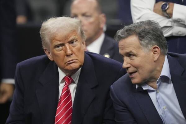 President Donald Trump, left, and Sen. Dave McCormick, R-Pa., attend the finals at the NCAA wrestling championship, Saturday, March 22, 2025, in Philadelphia. (AP Photo/Matt Rourke)