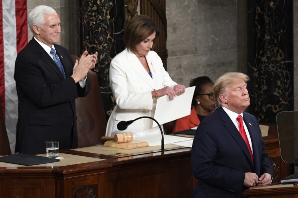 House Speaker Nancy Pelosi of Calif., tears her copy of President Donald Trump's s State of the Union address after he delivered it to a joint session of Congress on Capitol Hill in Washington, Feb. 4, 2020, as Vice President Mike Pence is at left. (AP Photo/Susan Walsh, File)