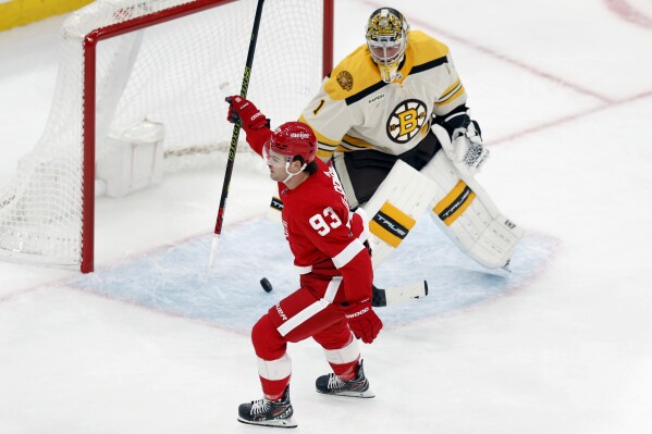 Detroit Red Wings' Alex DeBrincat (93) celebrates his goal against Boston Bruins' Jeremy Swayman (1) on a breakaway during the first period of an NHL hockey game, Friday, Nov. 24, 2023, in Boston. (AP Photo/Michael Dwyer)