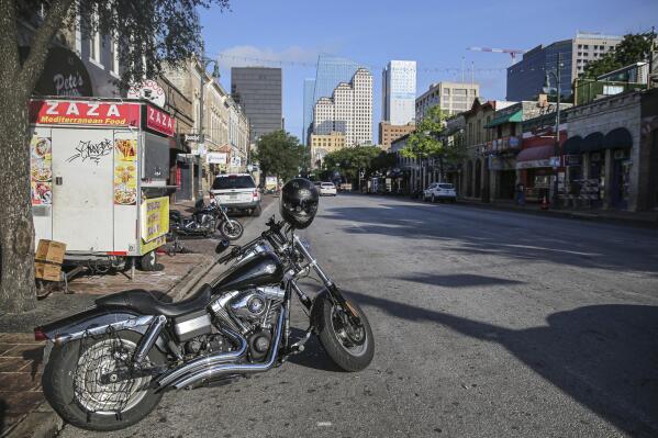 Some abandoned bikes are parked on the streets after a early morning shooting on Saturday, June 12, 2021 in downtown Austin, Texas. Authorities say someone opened fire on the busy entertainment district wounding several people before getting away.  (Aaron Martinez/Austin American-Statesman via AP)