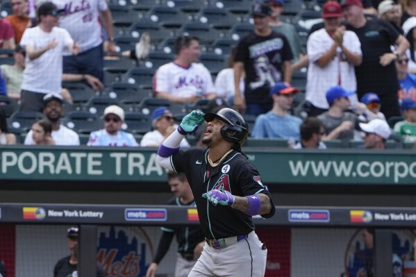 Arizona Diamondbacks' Ketel Marte celebrates before crossing home plate after hitting a two-run home run during the ninth inning of a baseball game against the New York Mets at Citi Field, Sunday, June 2, 2024, in New York. (AP Photo/Seth Wenig)
