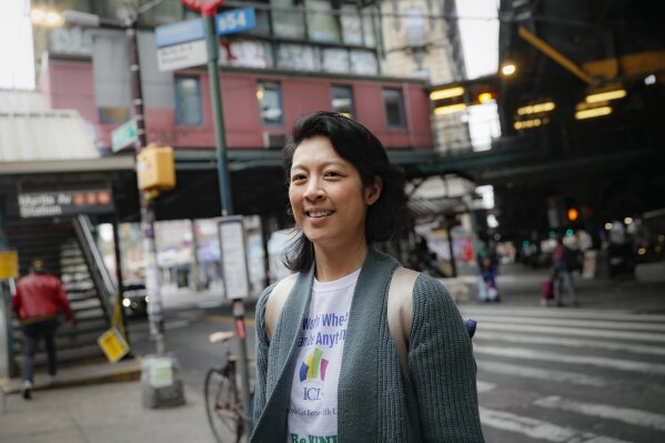 Dr. Jeanie Tse, chief medical officer at the Institute for Community Living, stands on a street corner during her rounds treating patients with psychiatric disorders including schizophrenia, Wednesday, May 6, 2020, in the Brooklyn borough of New York. (AP Photo/John Minchillo)