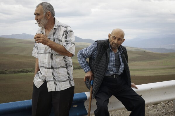 Ethnic Armenians fleeing Nagorno-Karabakh rest on the road to Kornidzor, in Armenia's Syunik region, Armenia, Tuesday, Sept. 26, 2023. (AP Photo/Vasily Krestyaninov)