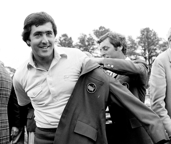 FILE - In this April 13, 1980 file photo, Seve Ballesteros of Spain, left, is helped with his Masters green jacket by the previous year's winner, Fuzzy Zoeller, right, after winning the 1980 Masters, in Augusta, Ga. Ballesteros had a 10-shot lead going to the back nine in the 1980 Masters before throwing away shots. His six-shot win was one of the most dominant Masters victories. (AP Photo/file)