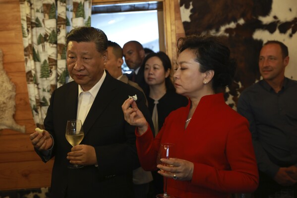 Chinese President Xi Jinping and his wife Peng Liyuan enjoy a drink in a restaurant, Tuesday, May 7, 2024 at the Tourmalet pass, in the Pyrenees mountains. French president is hosting China's leader at a remote mountain pass in the Pyrenees for private meetings, after a high-stakes state visit in Paris dominated by trade disputes and Russia's war in Ukraine. French President Emmanuel Macron made a point of inviting Chinese President Xi Jinping to the Tourmalet Pass near the Spanish border, where Macron spent time as a child visiting his grandmother. (AP Photo/Aurelien Morissard, Pool)