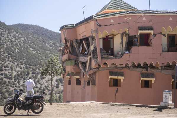 A man stands next to a damaged hotel after the earthquake in Moulay Brahim village, near the epicentre of the earthquake, outside Marrakech, Morocco, Saturday, Sept. 9, 2023. (AP Photo/Mosa'ab Elshamy)