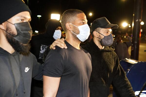 Actor Jussie Smollett, center, leaves the Cook County Jail Wednesday, March 16, 2022, after an appeals court agreed with his lawyers that he should be released pending the appeal of his conviction for lying to police about a racist and homophobic attack in Chicago. (AP Photo/Charles Rex Arbogast)