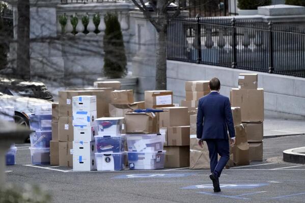 FILE - A man walks past boxes that were moved out of the Eisenhower Executive Office building, just outside the West Wing, inside the White House complex, Jan. 14, 2021, in Washington. The National Archives has asked former U.S. presidents and vice presidents to re-check their personal records for any classified documents following the news that President Joe Biden and former Vice President Mike Pence had such documents in their possession, two people familiar with the matter said Thursday, Jan. 26, 2023. (AP Photo/Gerald Herbert, File)