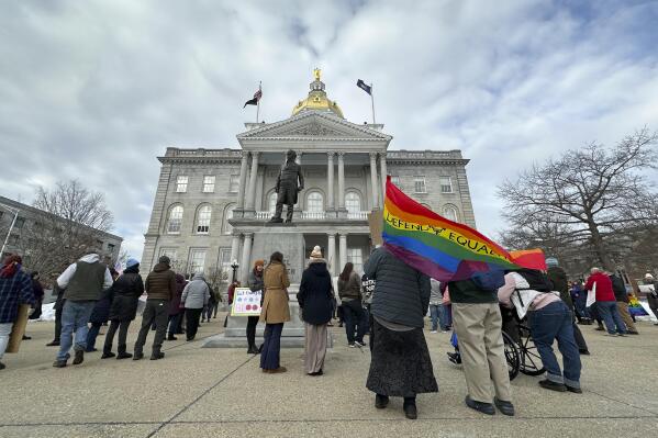 FILE - Advocates for transgender youth rally outside the New Hampshire Statehouse, in Concord, N.H., Tuesday, March 7, 2023. A nonprofit that launched last year to oppose diversity initiatives in medicine, has evolved into a significant leader in statehouses to ban gender-affirming care for transgender youths, producing model legislation that an Associated Press analysis found has been used in at least three states. (AP Photo/Holly Ramer, File)