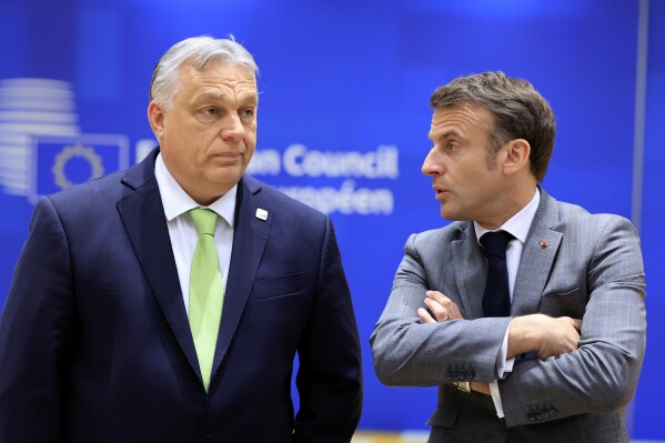 Hungary's Prime Minister Viktor Orban, left, speaks with French President Emmanuel Macron during a round table meeting at an EU Summit in Brussels, Thursday, March 21, 2024. European Union leaders are gathering to consider new ways to help boost arms and ammunition production for Ukraine. Leaders will also discuss in Thursday's summit the war in Gaza amid deep concern about Israeli plans to launch a ground offensive in the city of Rafah. (AP Photo/Geert Vanden Wijngaert)