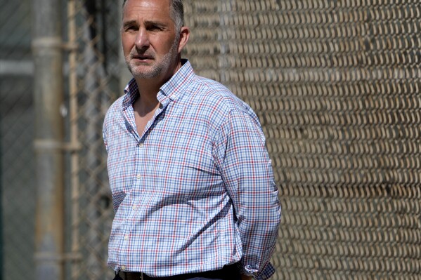 FILE - St. Louis Cardinals president of baseball operations John Mozeliak watches spring training baseball practice Feb. 15, 2023, in Jupiter, Fla. Authorities are seeking at least five people in an armed robbery of the Cardinals complex in the Dominican Republic, Friday, Oct. 13, 2023. A Dominican Republic police spokesman told The Associated Press that the suspects bound and gagged a security guard and stole watches, rings, necklaces and other items from athletes and personnel. (AP Photo/Jeff Roberson, File)