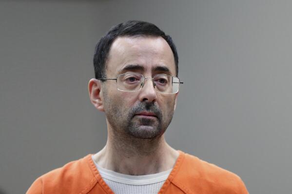 FILE - Dr. Larry Nassar, appears in court for a plea hearing on Nov. 22, 2017, in Lansing, Mich. The U.S. Justice Department said Thursday, May 26, 2022 it will not pursue criminal charges against former FBI agents who failed to quickly open an investigation of sports doctor Larry Nassar despite learning in 2015 that he was accused of sexually assaulting female gymnasts.(. (AP Photo/Paul Sancya File)