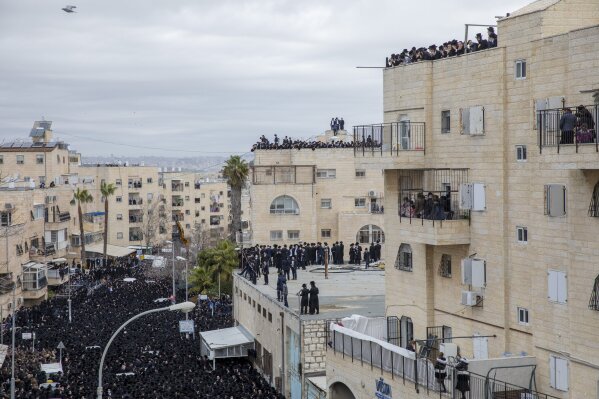 Thousands of ultra-Orthodox Jews participate in the funeral of prominent rabbi Meshulam Soloveitchik, flouting the country’s ban on large public gatherings amid the pandemic, in Jerusalem, Sunday, ...