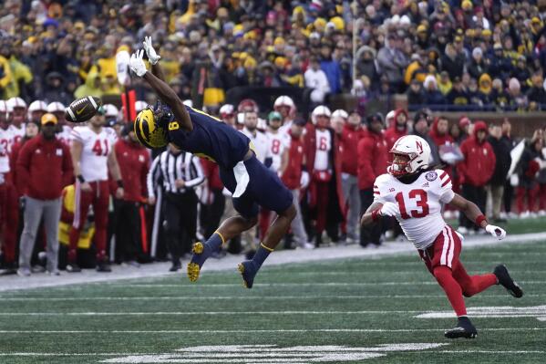 Michigan wide receiver Cornelius Johnson (6) can't pull in a pass as Nebraska defensive back Malcolm Hartzog (13) defends in the first half of an NCAA college football game in Ann Arbor, Mich., Saturday, Nov. 12, 2022. (AP Photo/Paul Sancya)